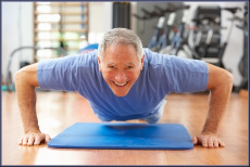 Elderly man exercising, doing push ups, smiling